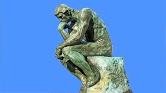 A statue of the thinker on a blue background.
