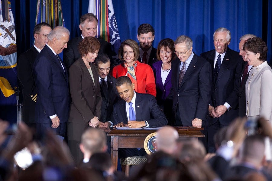 Flanked by members of Congress and then-Vice President Joe Biden, President Obama signs the act repealing “don’t ask, don’t tell.” 