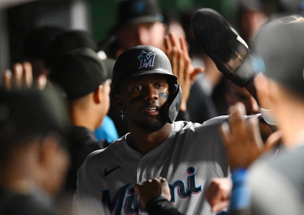 Jorge Soler of the Miami Marlins celebrates with teammates in the dugout after scoring during the eighth inning against the Pittsburgh Pirates at PNC...