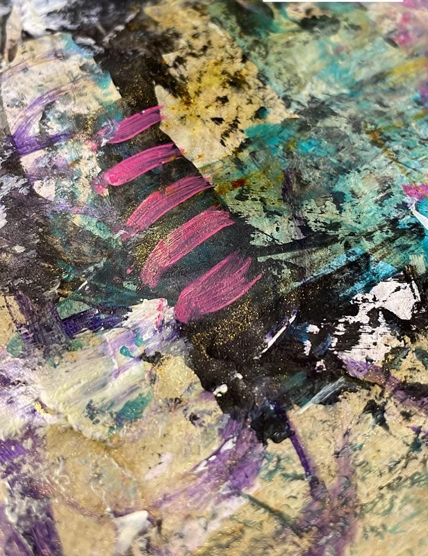 close up of a section of a mixed media paper in back and pink with some blues and white and gold glitter