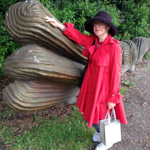 Woman in red coat and big black hat
