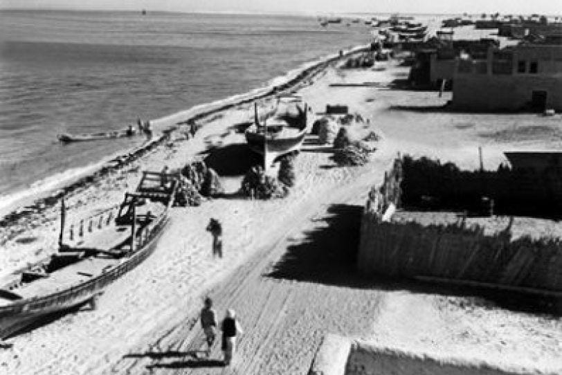 Aerial view of a small settlement along the UAE coast in the 1960s