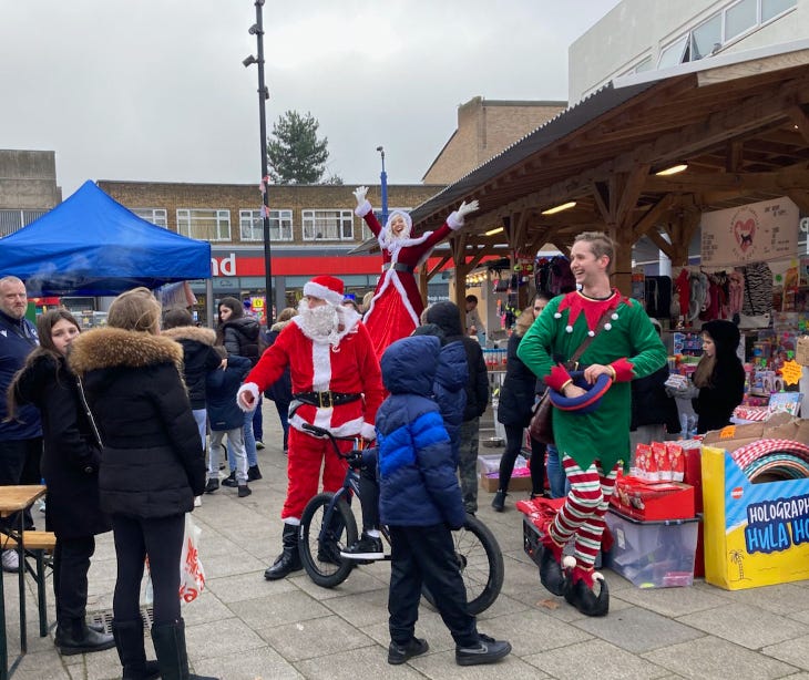 People dressed as Santa and elves mingling with crowds