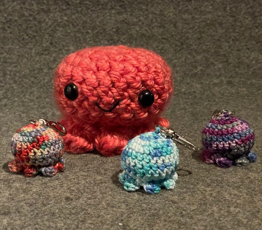 Photo of multiple crocheted octopi in different colours and sizes