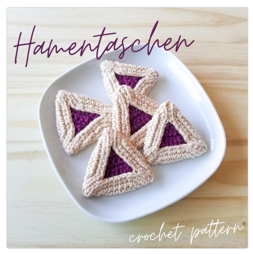 Image of crocheted hamentaschen, aka linzer cookies, on a plate 