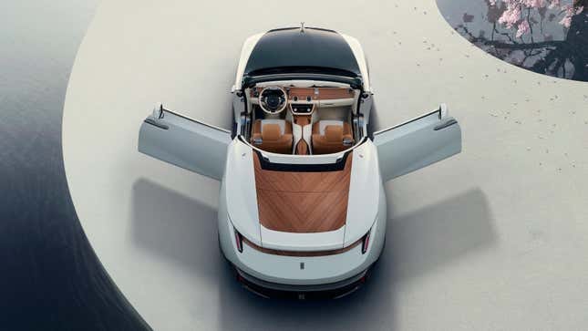 High-up rear view of a white Rolls-Royce Droptail with the doors open