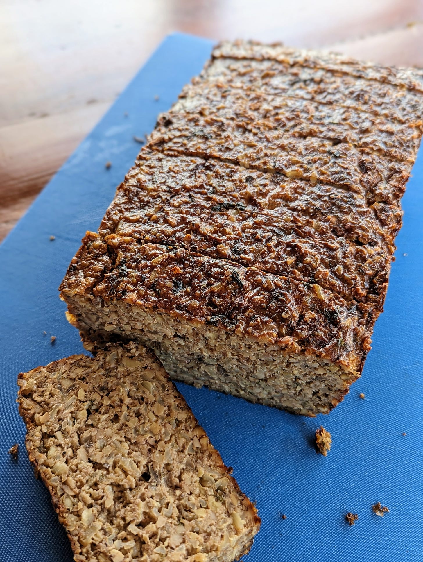 A cutting board with sliced vegetarian nut loaf.