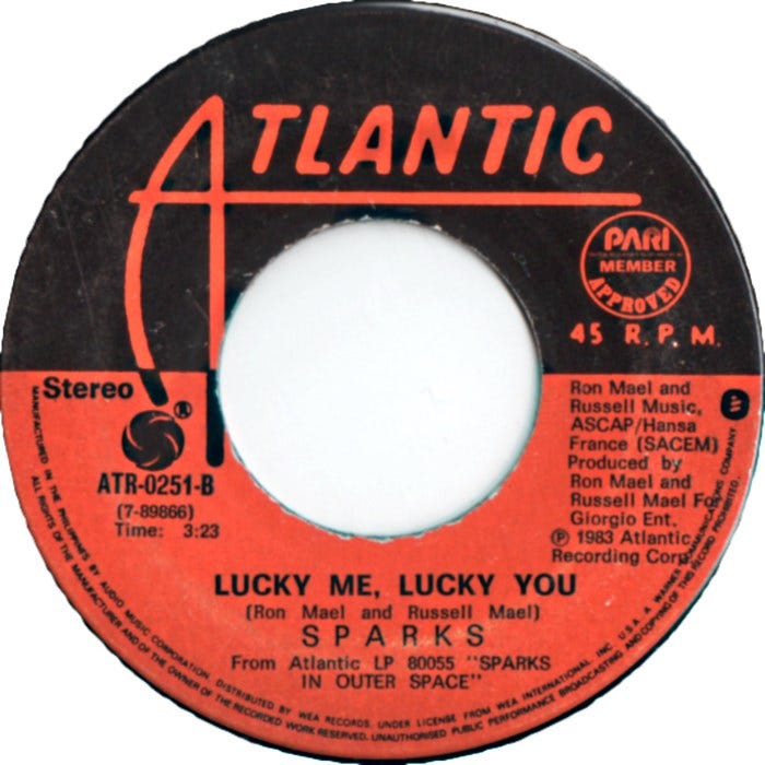 A 45 RPM vinyl single of 'Lucky Me, Lucky You'.