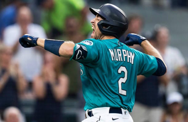 Tom Murphy of the Seattle Mariners celebrates after hitting a two-run home run off of starting pitcher Robbie Ray of the Toronto Blue Jays, also...