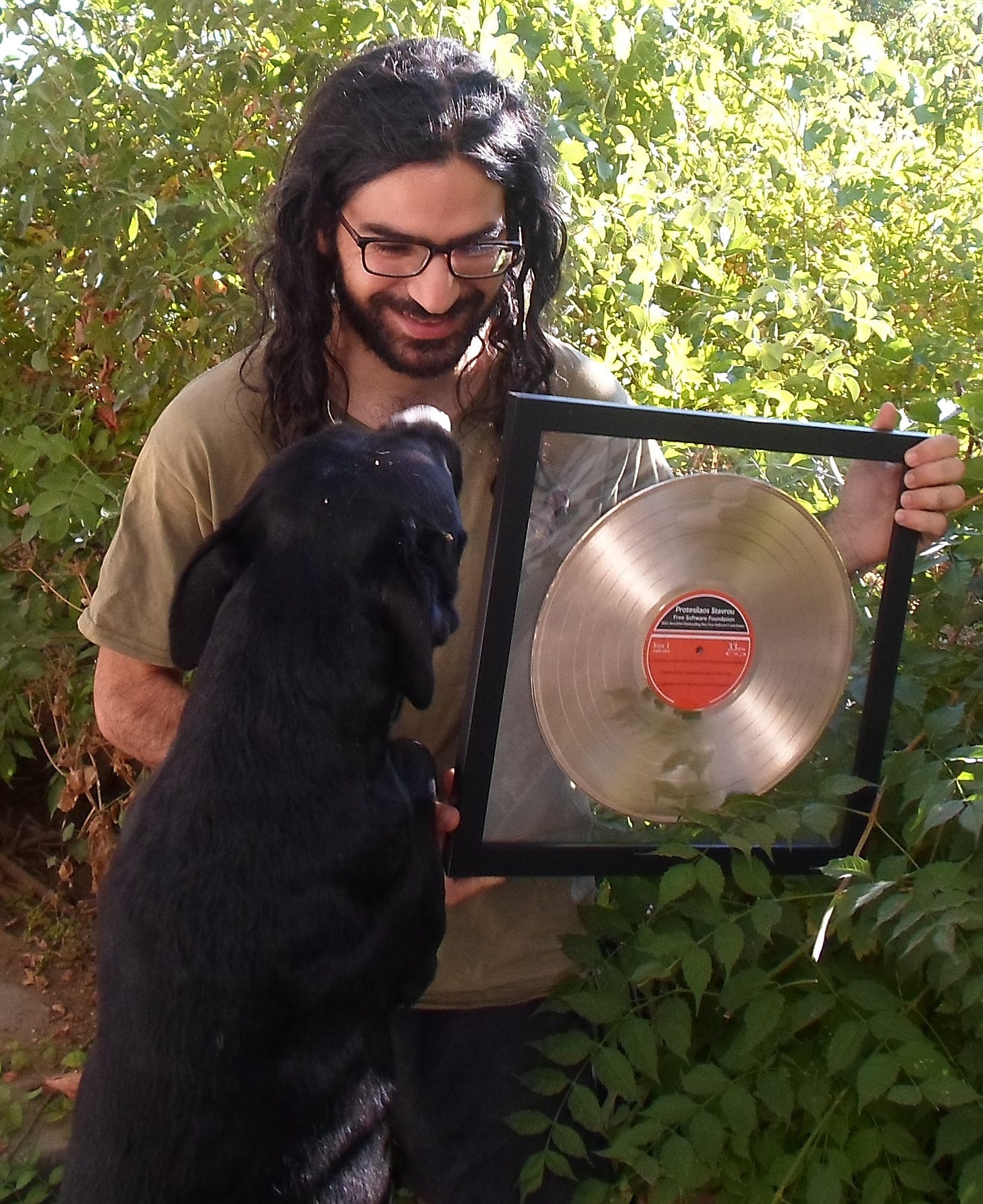 Prot with his dog and an award.