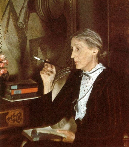 Virginia Woolf smoking at her desk