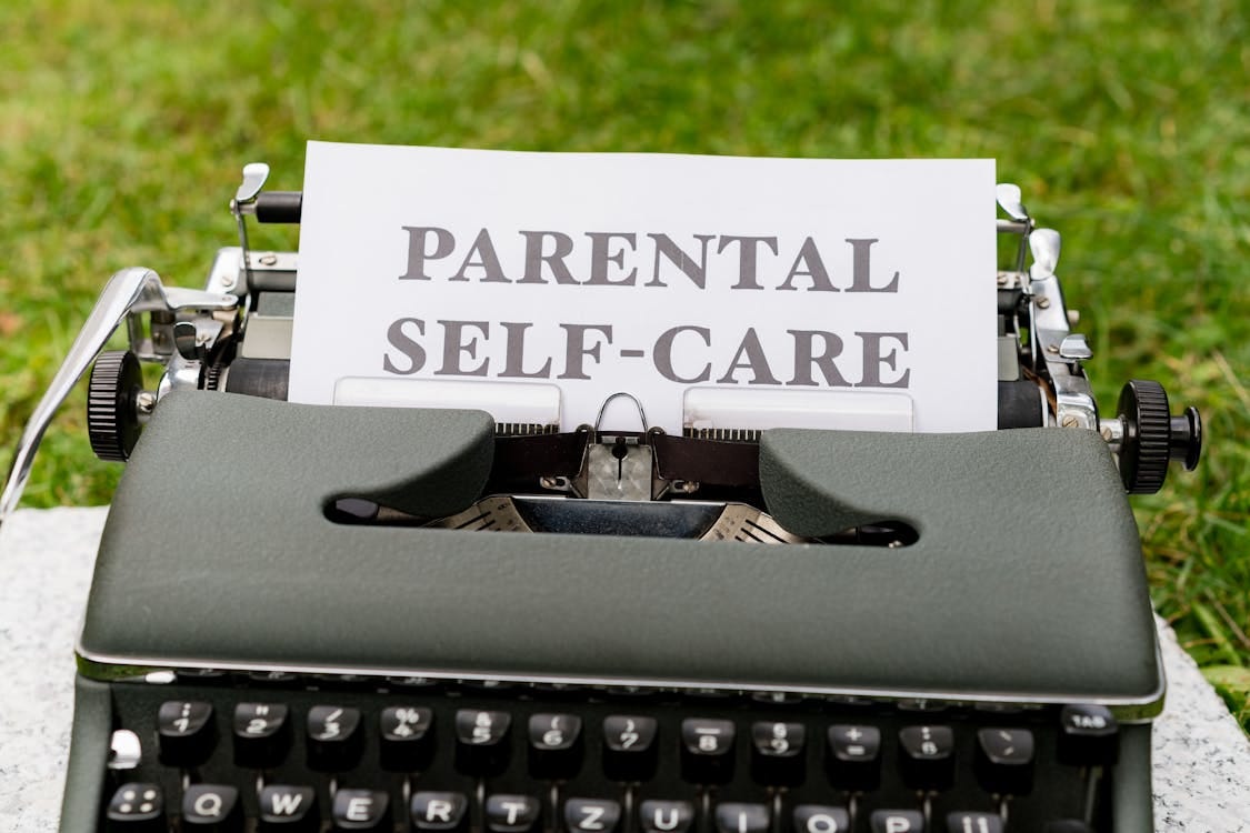 Free A typewriter with a paper that says parental self care Stock Photo