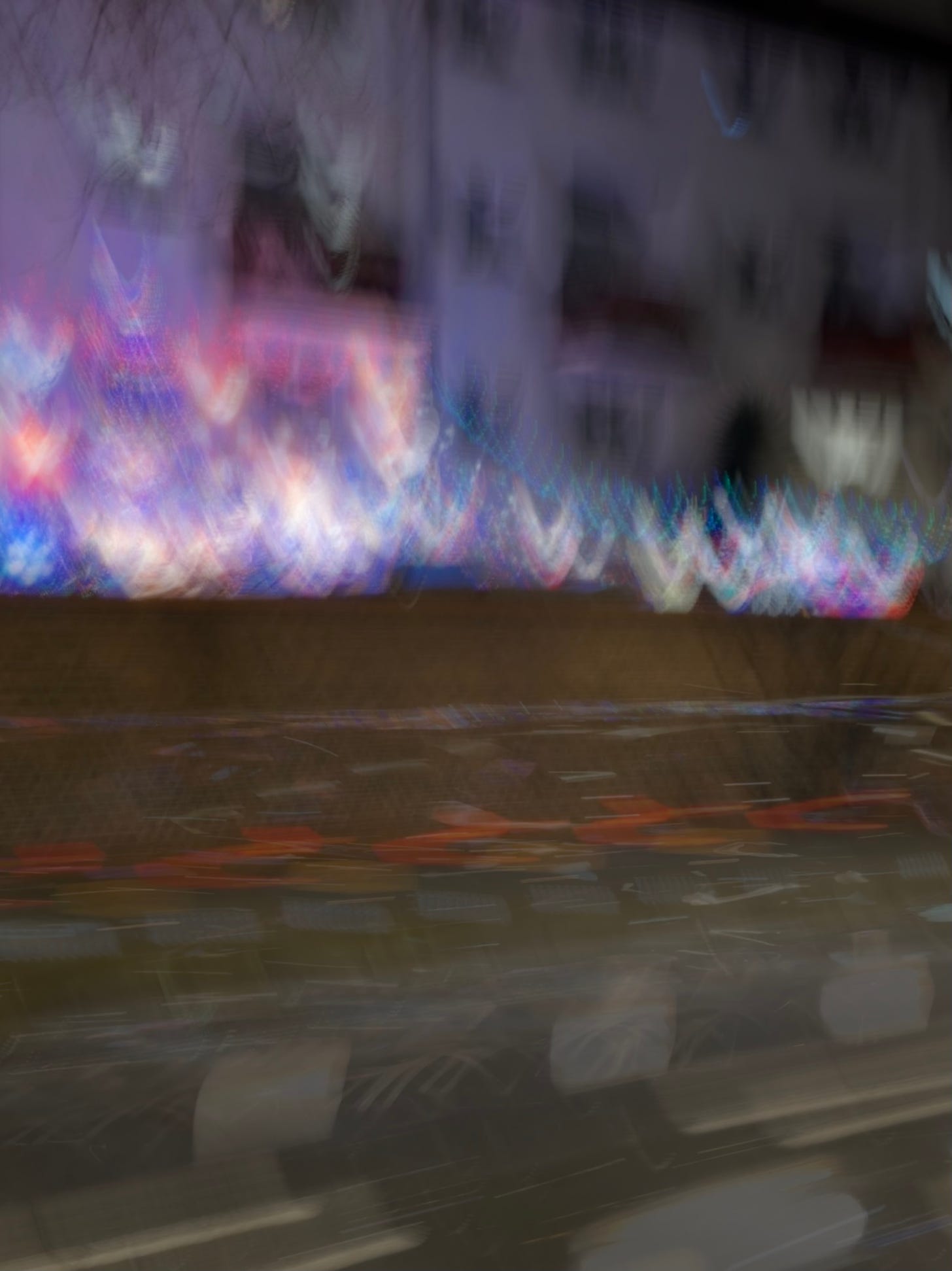 Accidental blurred photo that shows patterns of pink, purple, blue and movement lines of a blurred car.