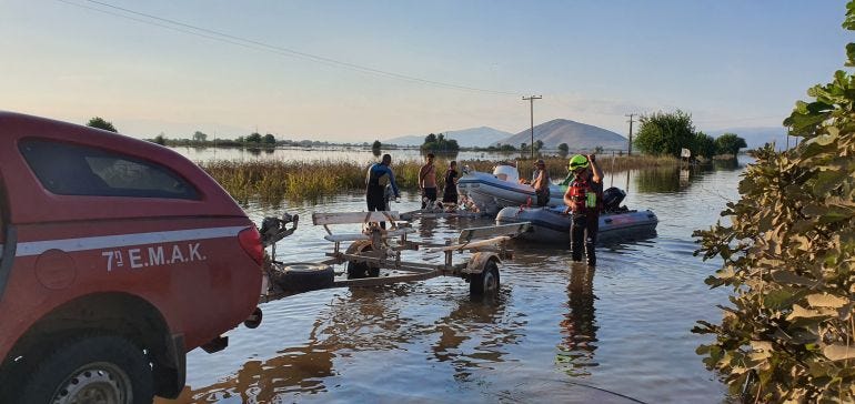 Fire fighters helping people during severe flooding