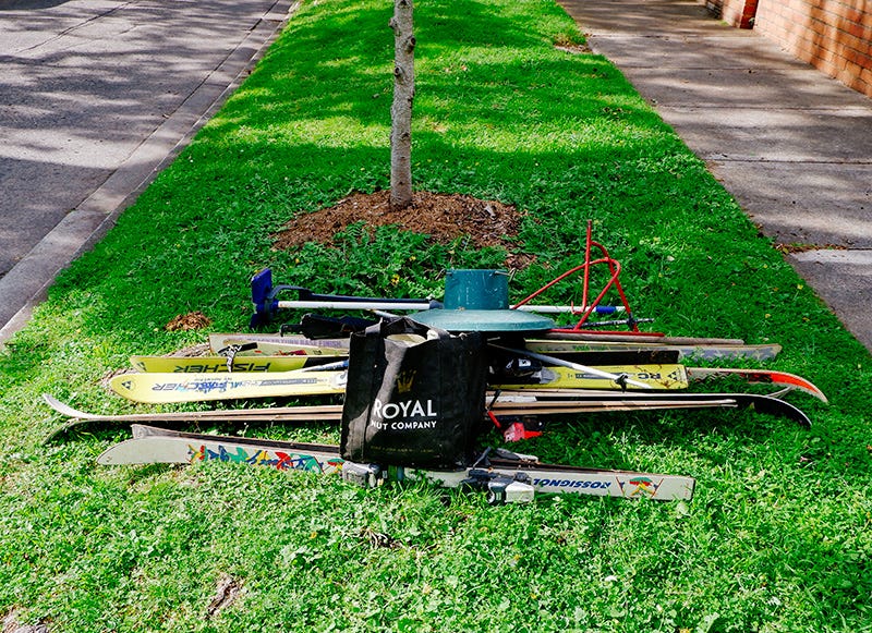 a pile with skis on a nice nature strip