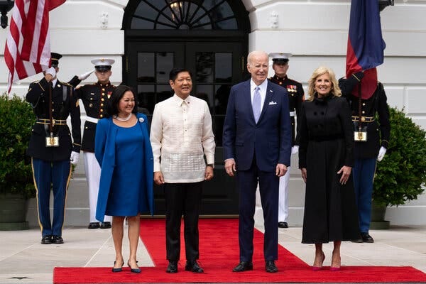 President Joe Biden, Dr. Jill Biden, President Ferdinand Marcos Jr. and his wife pose for a photo on a red carpet at the White House.