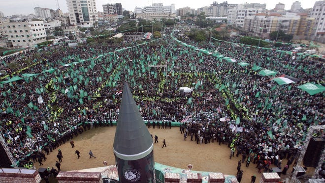 A large model of a M75 long range rocket  is seen as thousands of Hamas supporters gather during a rally in Gaza city.