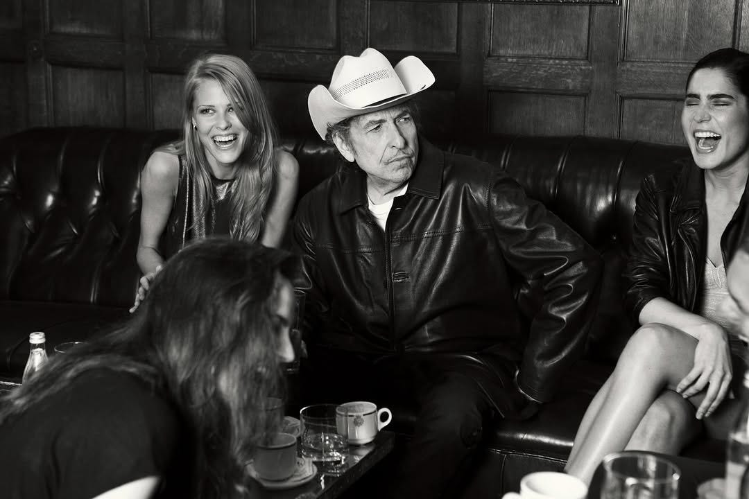 May be a black-and-white image of 4 people, leather and text