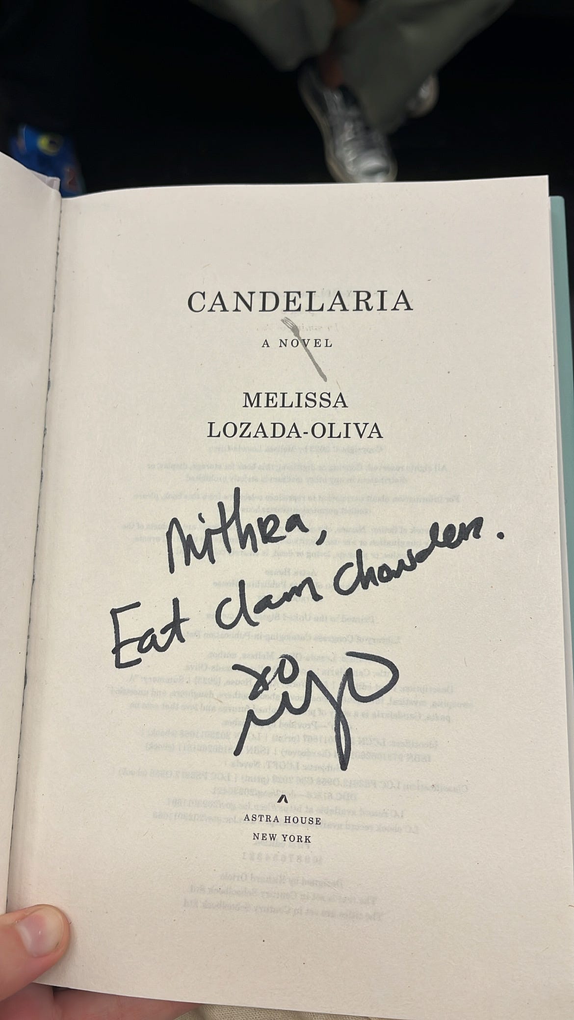 signed book copy that reads "mithra, eat clam chowder."