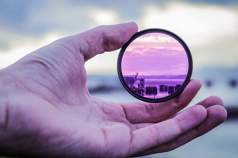 Hand holding a camera lens