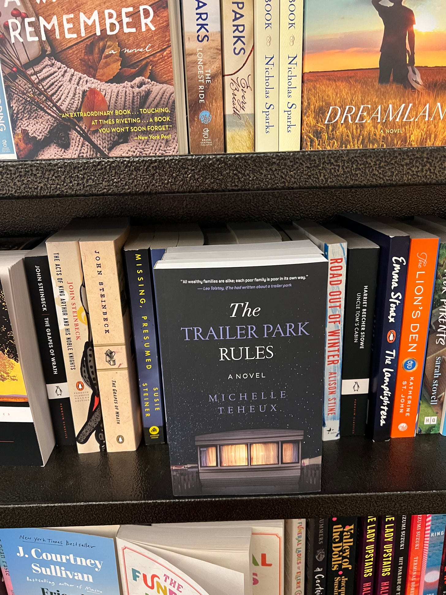 A copy of the book The Trailer Park Rules is seen on a bookstore shelf.