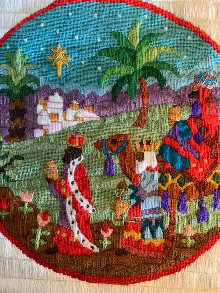 Colorful needlepoint depicting the story of Epiphany. Three magi travel the Mediterranean during antiquity bearing gifts.