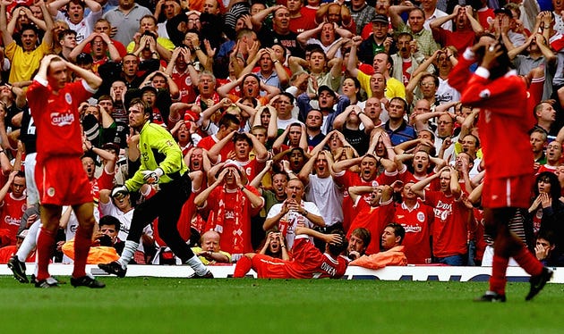Michael Owen, his Liverpool teammates and the crowd holding their heads after Manchester United goalkeeper Massimo Taibi saved a shot during a 1999 match between the two rivals (Phil Noble/PA Archive/Press Association Images)