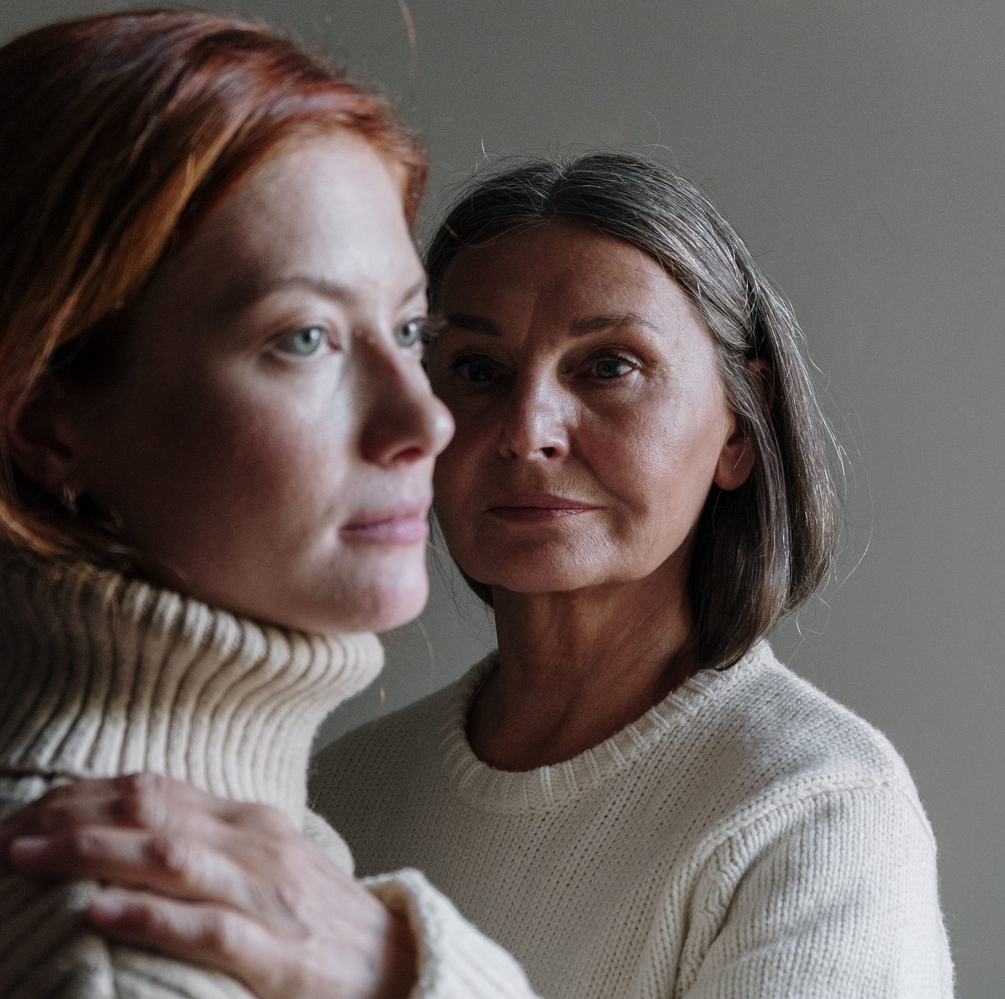 Color photo of a young woman and an older woman in knit sweaters