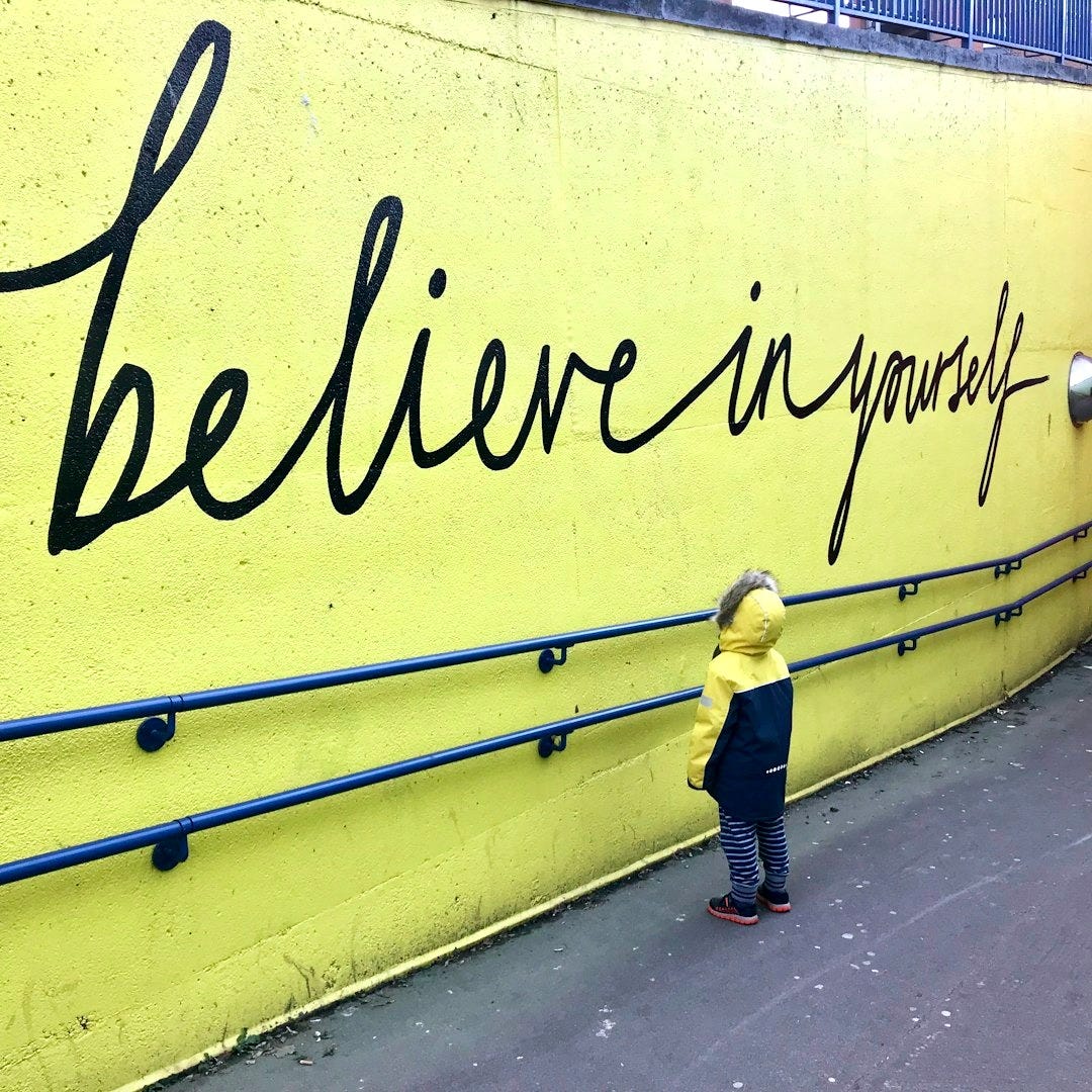 toddler looking at believe in yourself graffiti toddler looking at believe in yourself graffiti