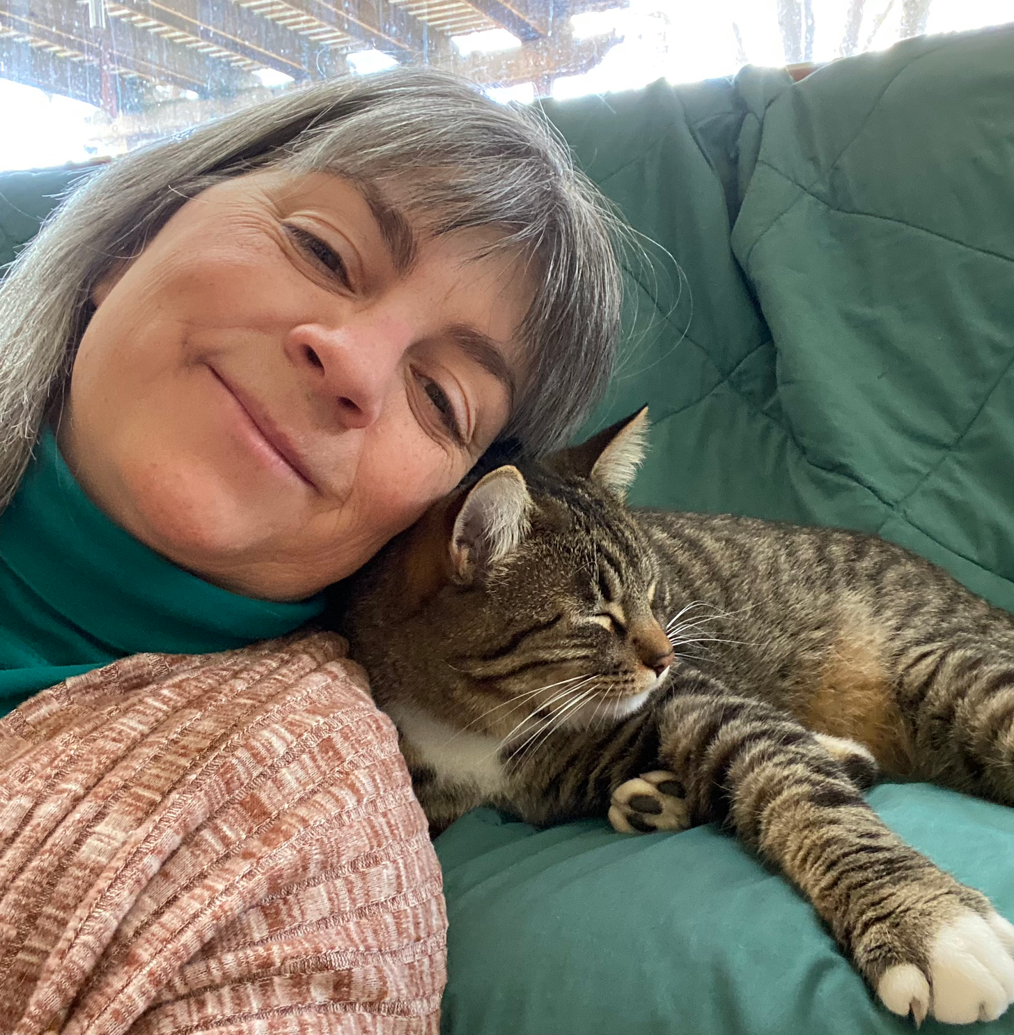 The author relaxing with one of the family cats