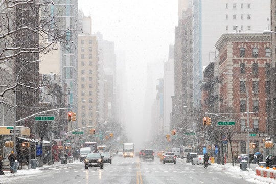 Snowy winter street scene looking down 3rd Avenue in the East Village of  Manhattan during a nor'easter snowstorm in New York City Stock Photo |  Adobe Stock