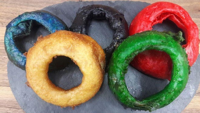 In New York City, Slate chef Darryl Harmon is offering $5 Olympic ring-themed onion rings for guests watching the games on the 40 TVs throughout the venue.