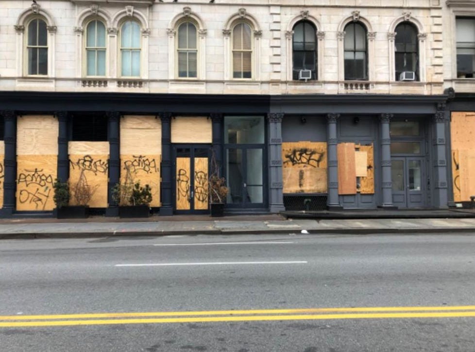 A building with boarded up windows

AI-generated content may be incorrect.
