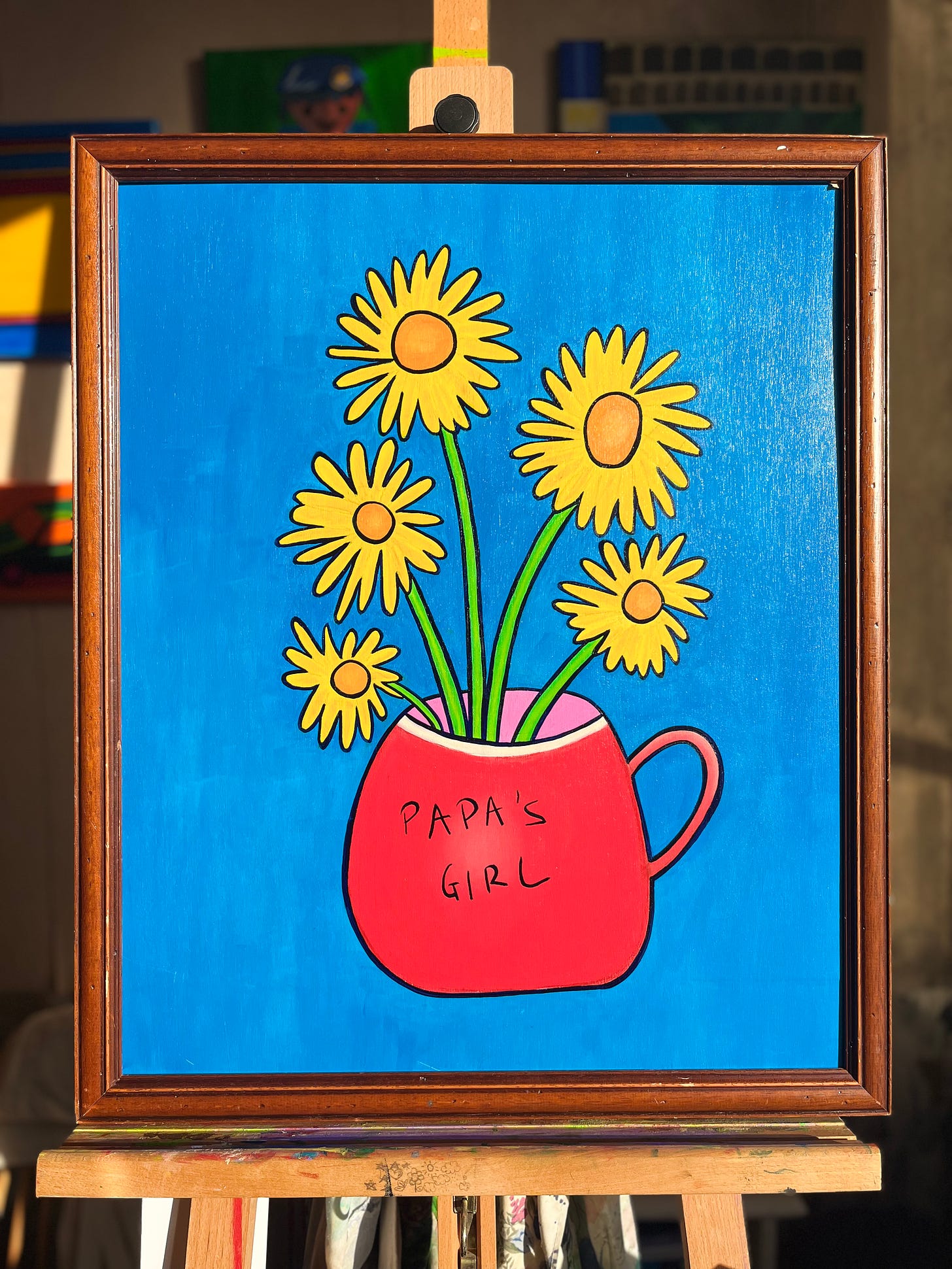 An oil painting of five yellow flowers in a red cup with the words Papa's Girl