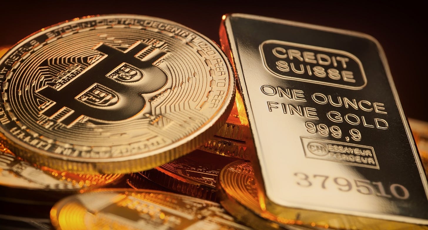 Moneda de Bitcoin junto a lingote de oro