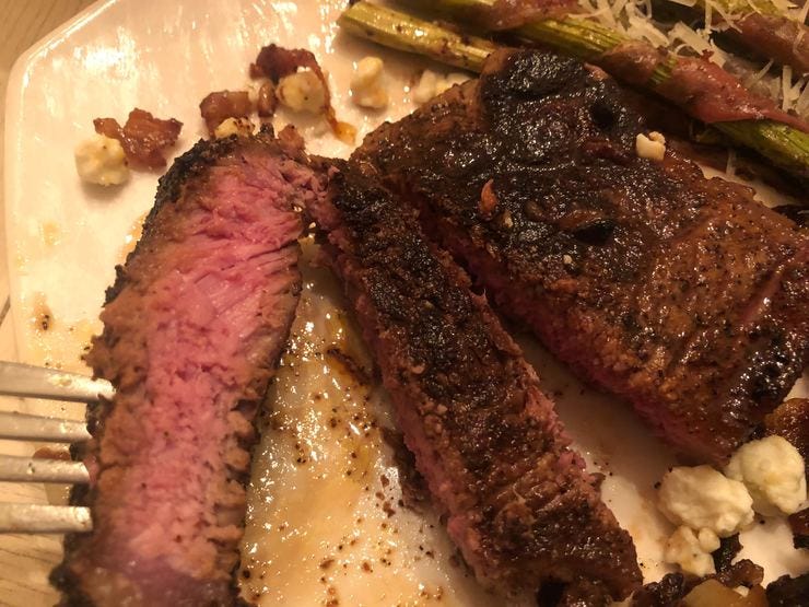 Steak seasoned with Spiceology Cowboy Crust covered with crispy shallots and blue cheese