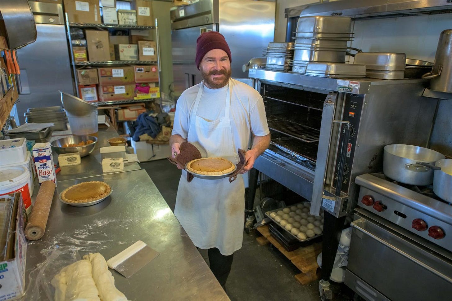 man baking pies at research station