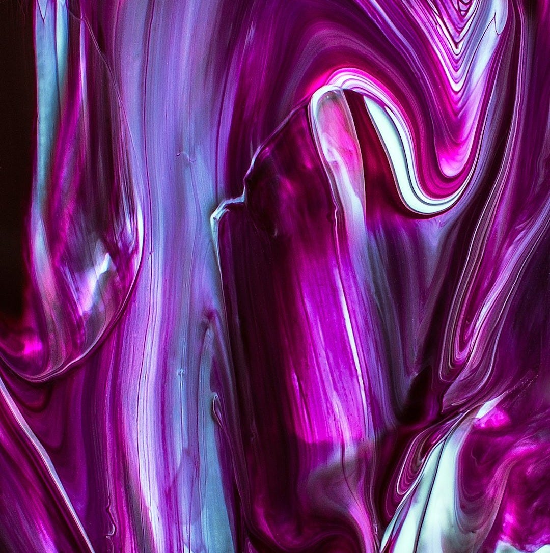 a close up of a purple and white abstract painting