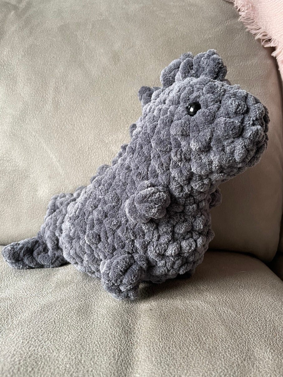 Photo of a crocheted T-rex in bulky grey yarn