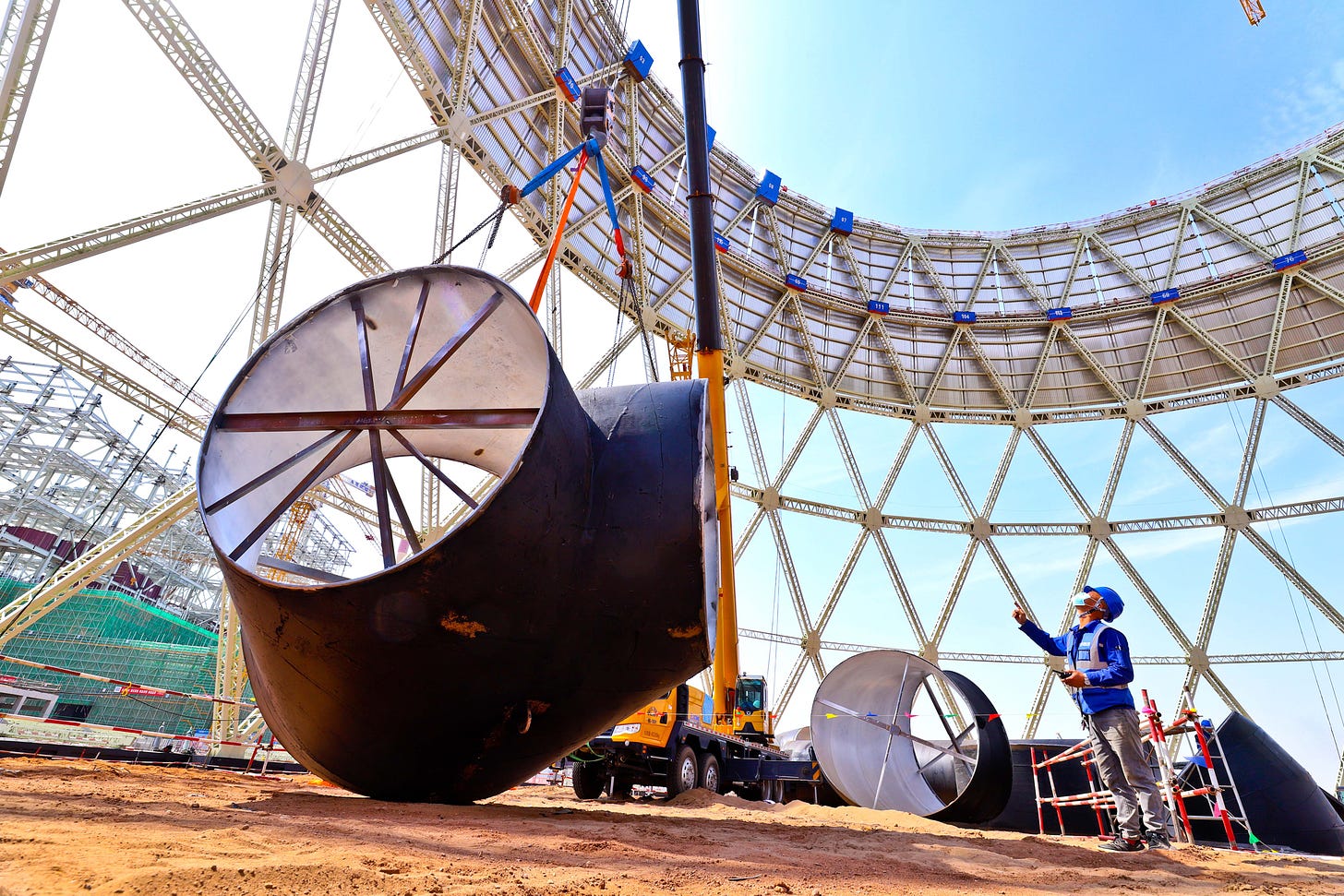 Builders install a cooling tower ventilation pipe at the site of a coal-fired unit expansion project on May 2 in Zhangye, China. Credit: Costfoto/NurPhoto via Getty Images