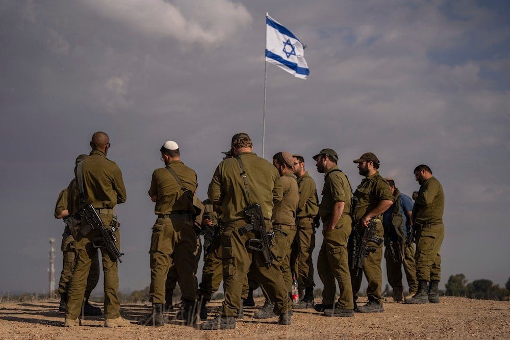 Israeli soldiers congregate on a hill close to the Gaza border in southern occupied Palestine, on December 5, 2024 (AP).