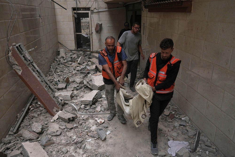 Palestinian civil defense workers carry the remains of a person killed during an Israeli airstrike on a residential building in Gaza City, Thursday, April 24, 2025. (AP) Palestinian civil defense workers carry the remains of a person killed during an Israeli airstrike on a residential building in Gaza City, Thursday, April 24, 2025. (AP)