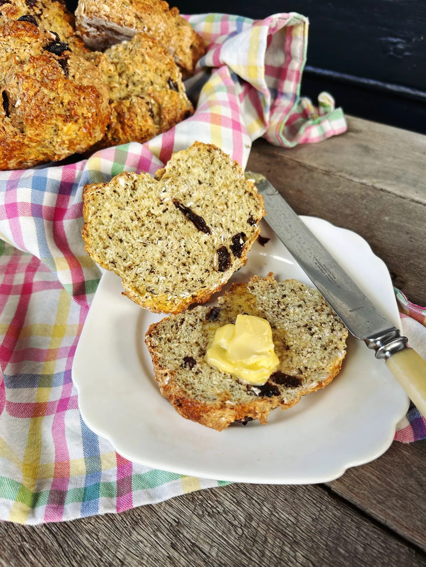 Fresh baked soda buns spread with butter.