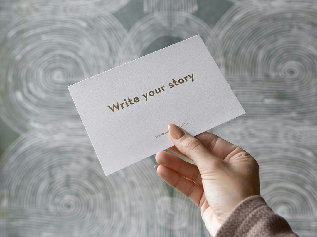 a person holding a piece of paper with writing on it