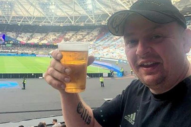 Matthew enjoying a beer while watching Soccer Aid in London Stadium