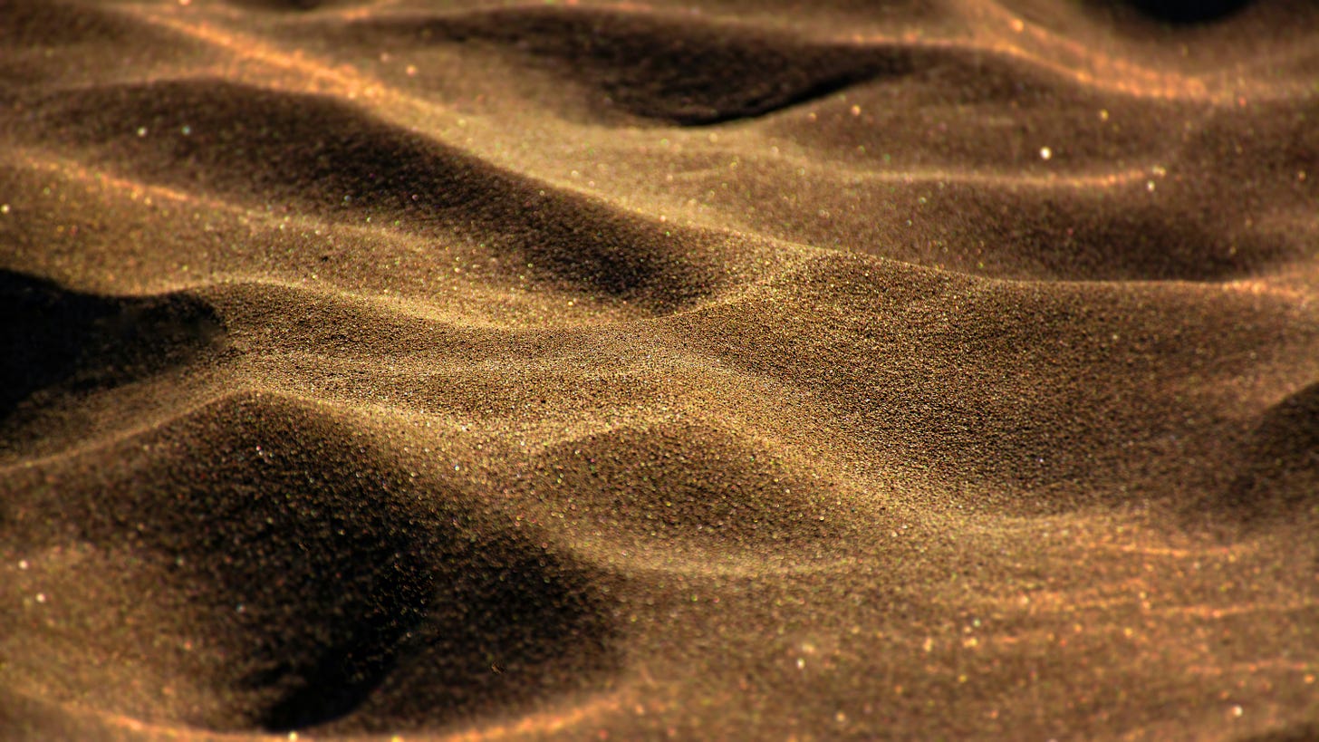 A close-up image of sparkling, golden sand