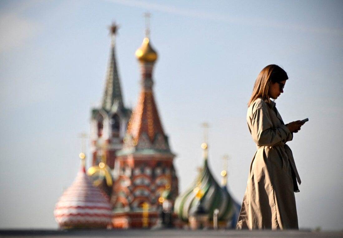 A woman walks in front of the Kremlin on September 23, 2024. U.S. intelligence officials say Russia has embraced artificial intelligence tools to try to sway American voters ahead of the November election.