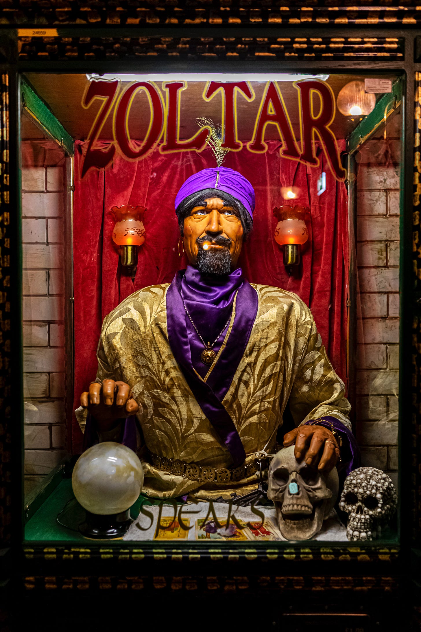 Image of the Zoltar fortune-telling booth with Zoltar's hand on a skull and crystal ball.