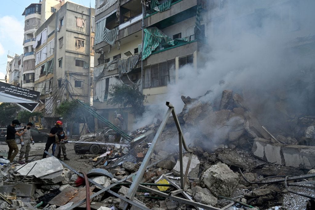 Rescue workers try to extinguish a fire following an Israeli airstrike in the Al-Chiyah area in southern Beirut, Lebanon, 13 November 2024