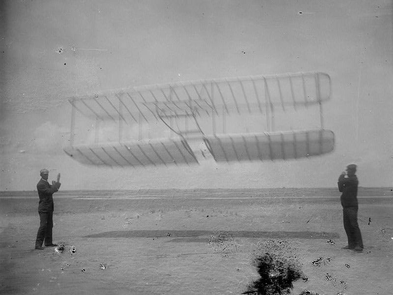 The Wrights flying their glider from the ground.